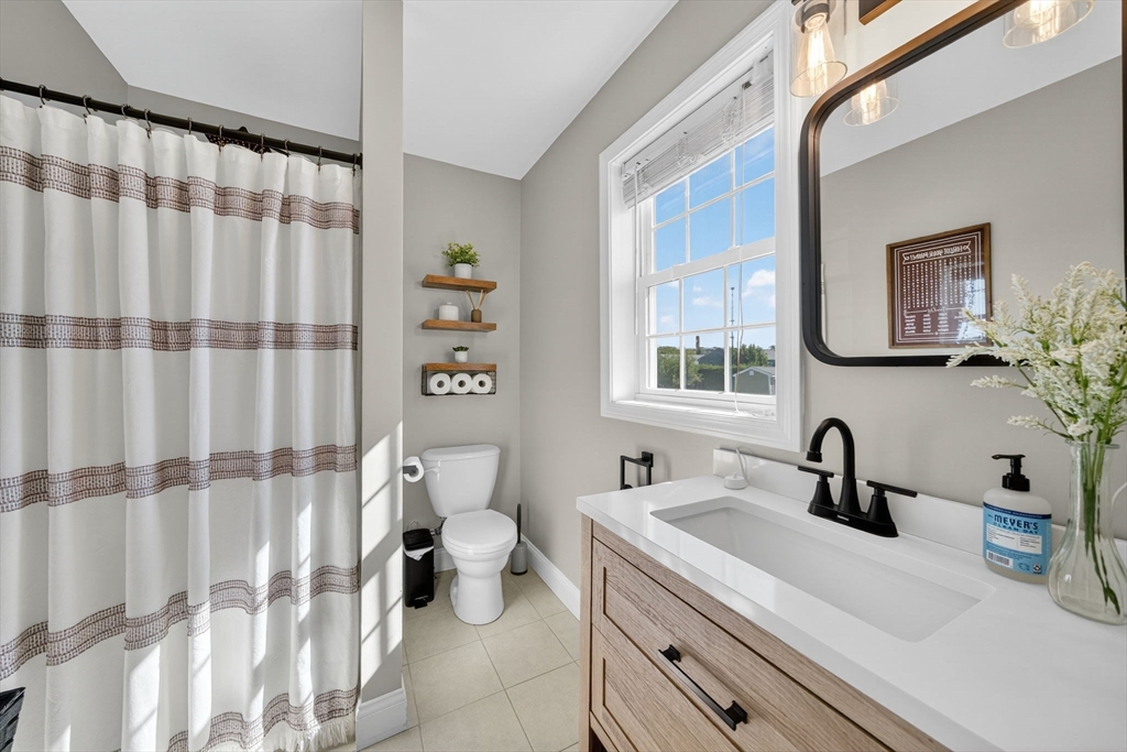 750 Cambridge Street Fall River, MA 02721 - Photo 14 of 38 a bathroom with a sink a toilet and a large mirror