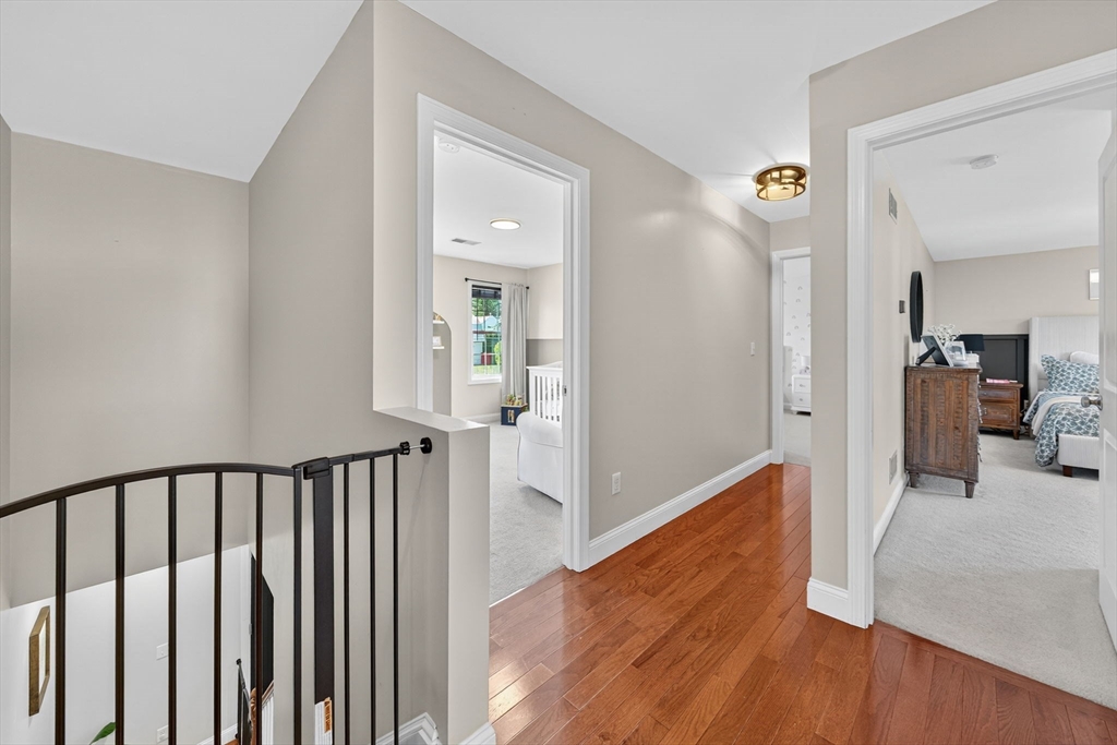 750 Cambridge Street Fall River, MA 02721 - Photo 17 of 38 a view of a hallway with wooden floor and a living room