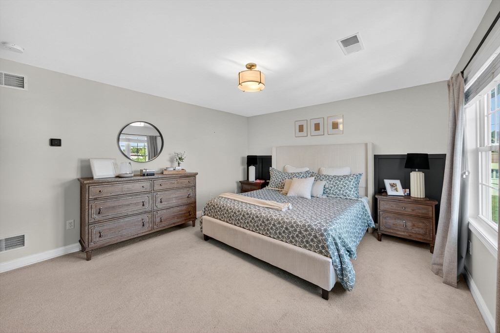 750 Cambridge Street Fall River, MA 02721 - Photo 21 of 38 a bedroom with a bed and a chandelier