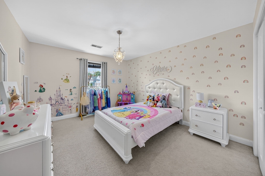 750 Cambridge Street Fall River, MA 02721 - Photo 25 of 38 a bedroom with a bed and a chandelier