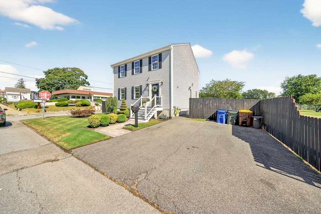750 Cambridge Street Fall River, MA 02721 - Photo 3 of 38 a front view of a house with a yard and table and chairs