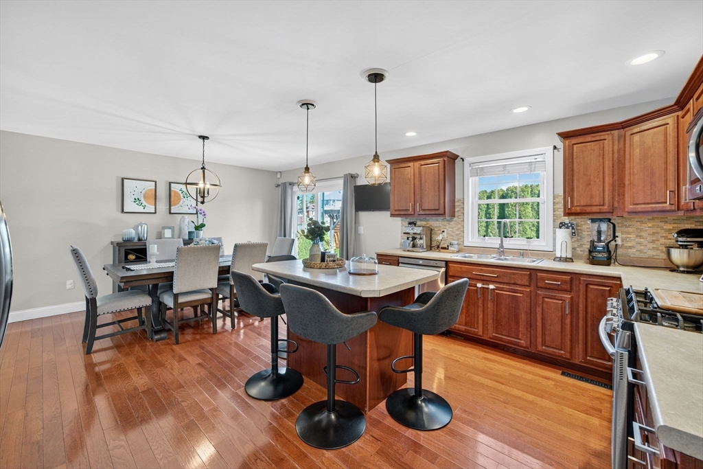 750 Cambridge Street Fall River, MA 02721 - Photo 10 of 38 a kitchen with stainless steel appliances granite countertop a table chairs sink refrigerator and microwave