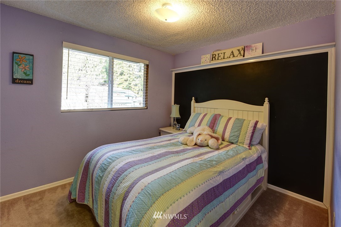 2206 168th Street Southeast Bothell, WA 98012 - Photo 12 of 21 a bedroom with a bed and a window