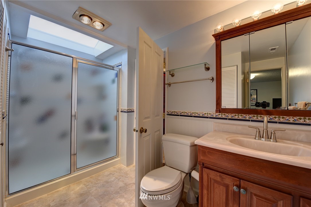 2206 168th Street Southeast Bothell, WA 98012 - Photo 16 of 21 a bathroom with a shower sink vanity mirror and toilet