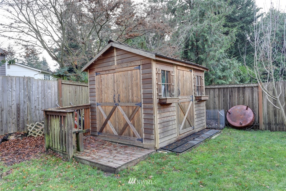 2206 168th Street Southeast Bothell, WA 98012 - Photo 21 of 21 a view of backyard with wooden fence and a large tree