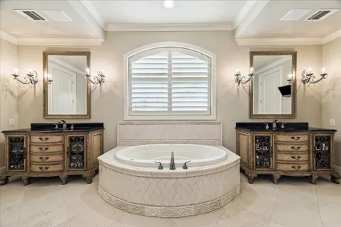 a spacious bathroom with a double vanity sink a large mirror and a shower