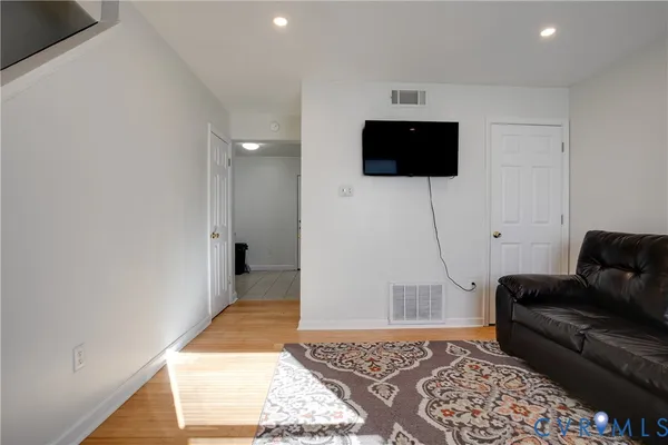 a living room with a couch and a rug