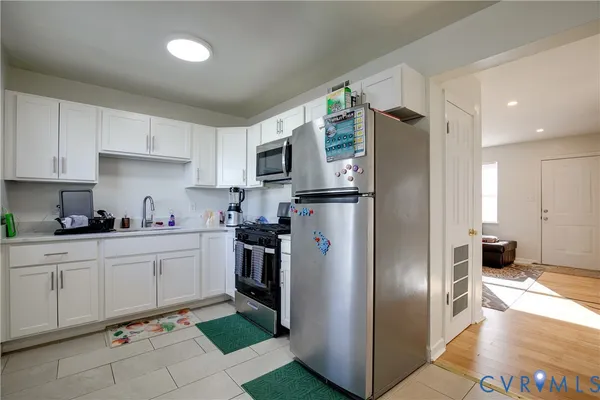 a kitchen with cabinets and stainless steel appliances