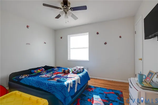 a bedroom with a bed and flat screen tv