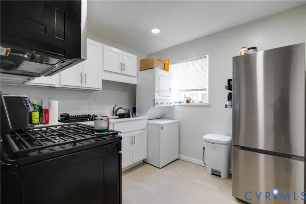 a kitchen with a refrigerator and a stove top oven
