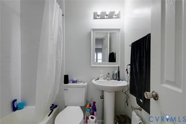 a bathroom with a sink mirror toilet and shower