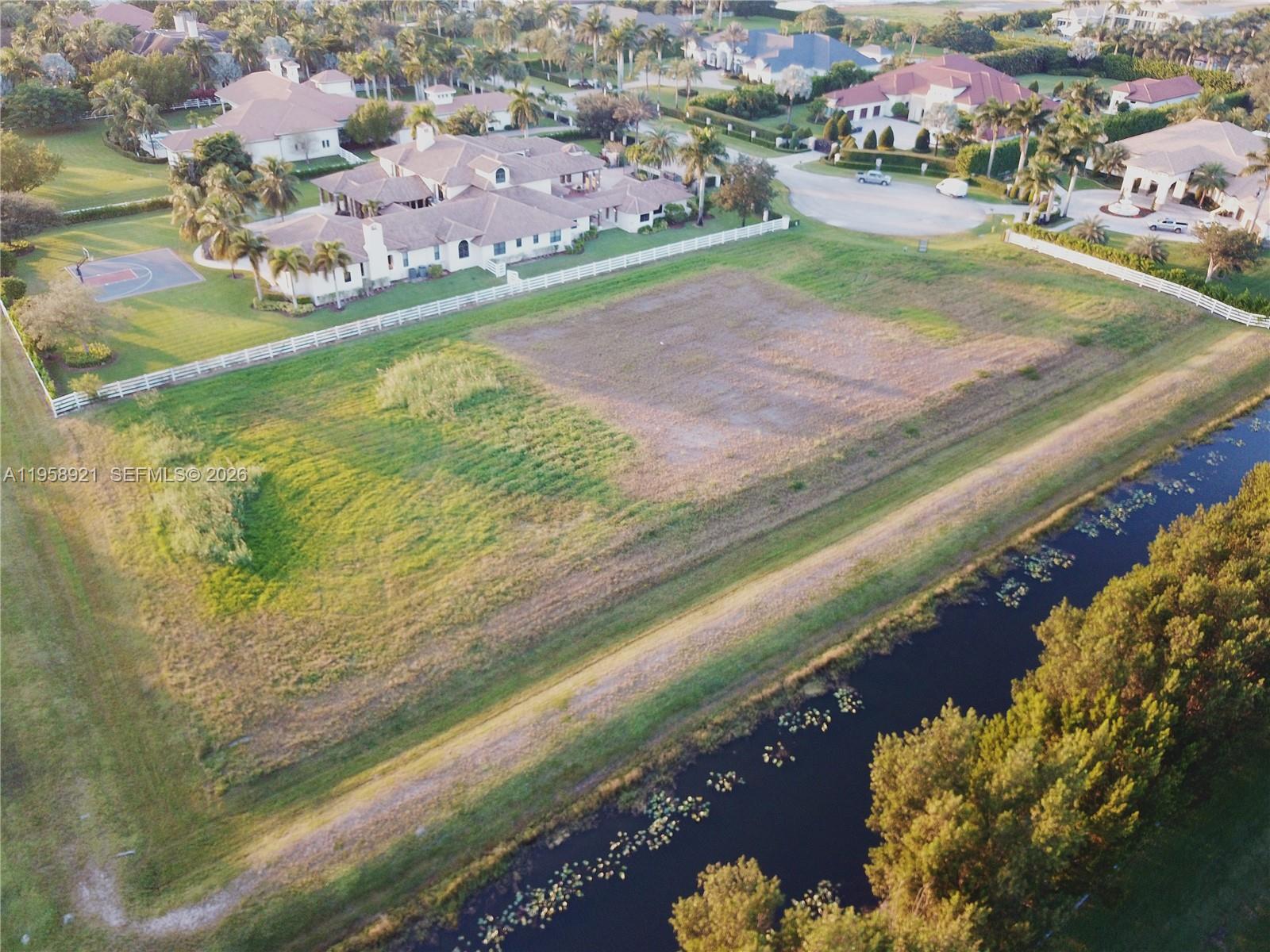 16700 Berkshire Court Southwest Ranches, FL 33331 - Photo 3 of 11 a view of a lake with a houses