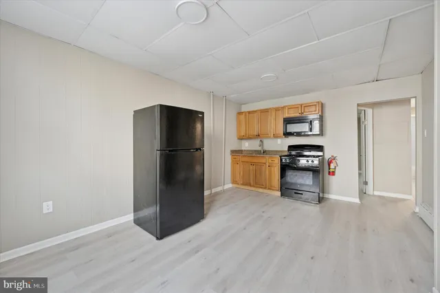 a kitchen with a refrigerator and a stove