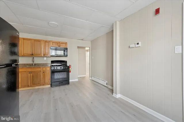 a kitchen with stainless steel appliances a refrigerator and a stove top oven
