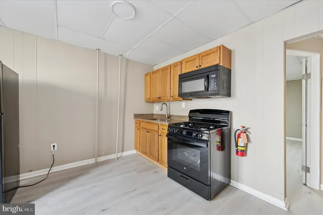 a kitchen with stainless steel appliances granite countertop a stove and a refrigerator