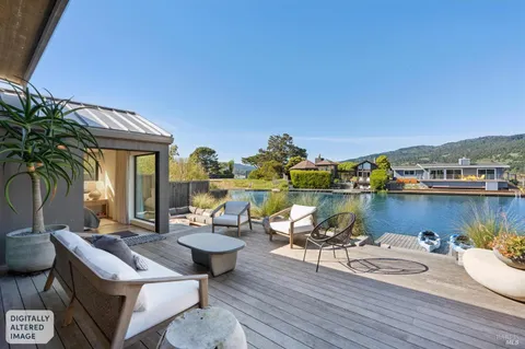 a view of a house with swimming pool and outdoor seating