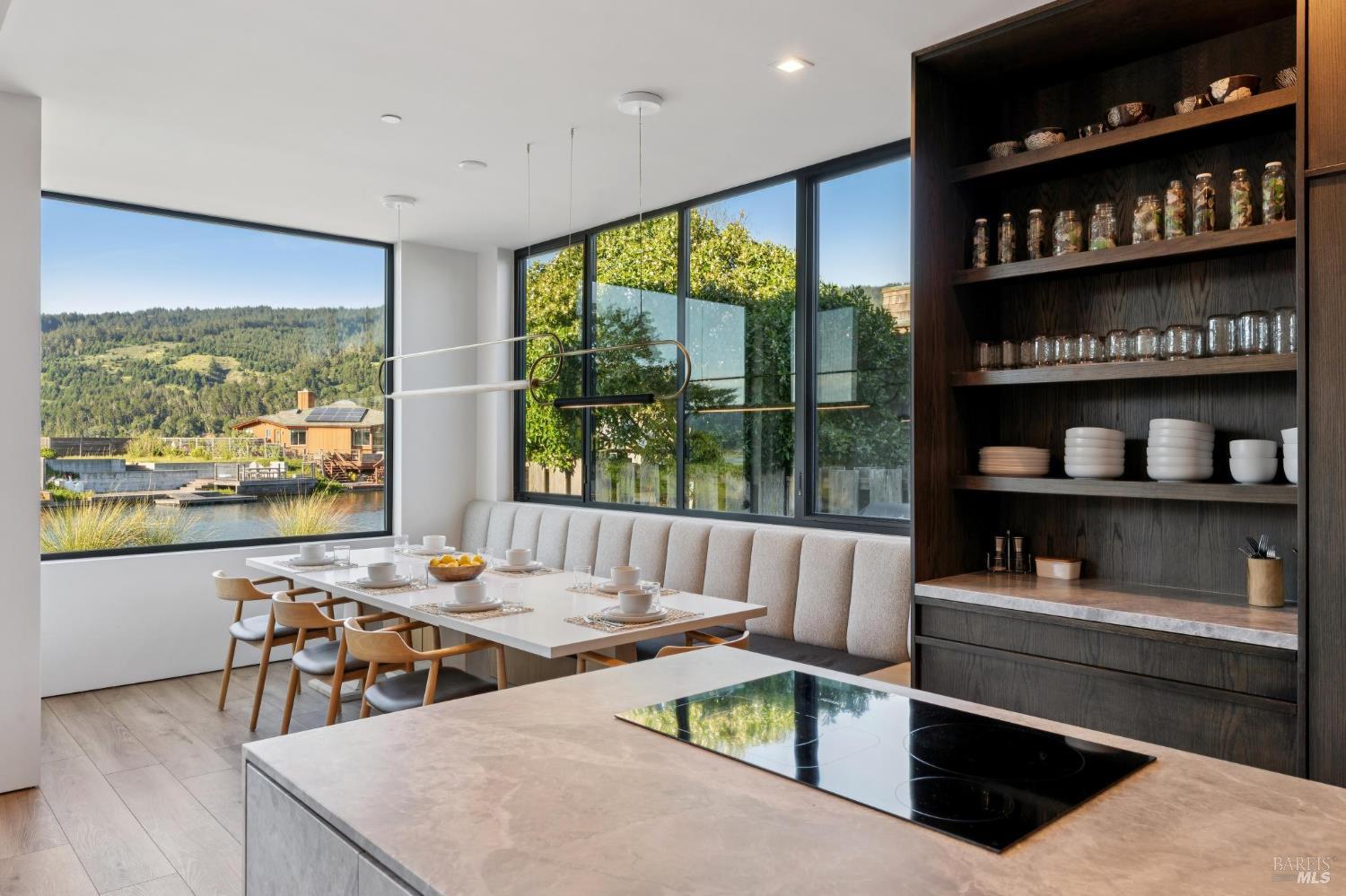 297 Seadrift Road Stinson Beach, CA 94970 - Photo 21 of 68 a living room with furniture a rug and a floor to ceiling window