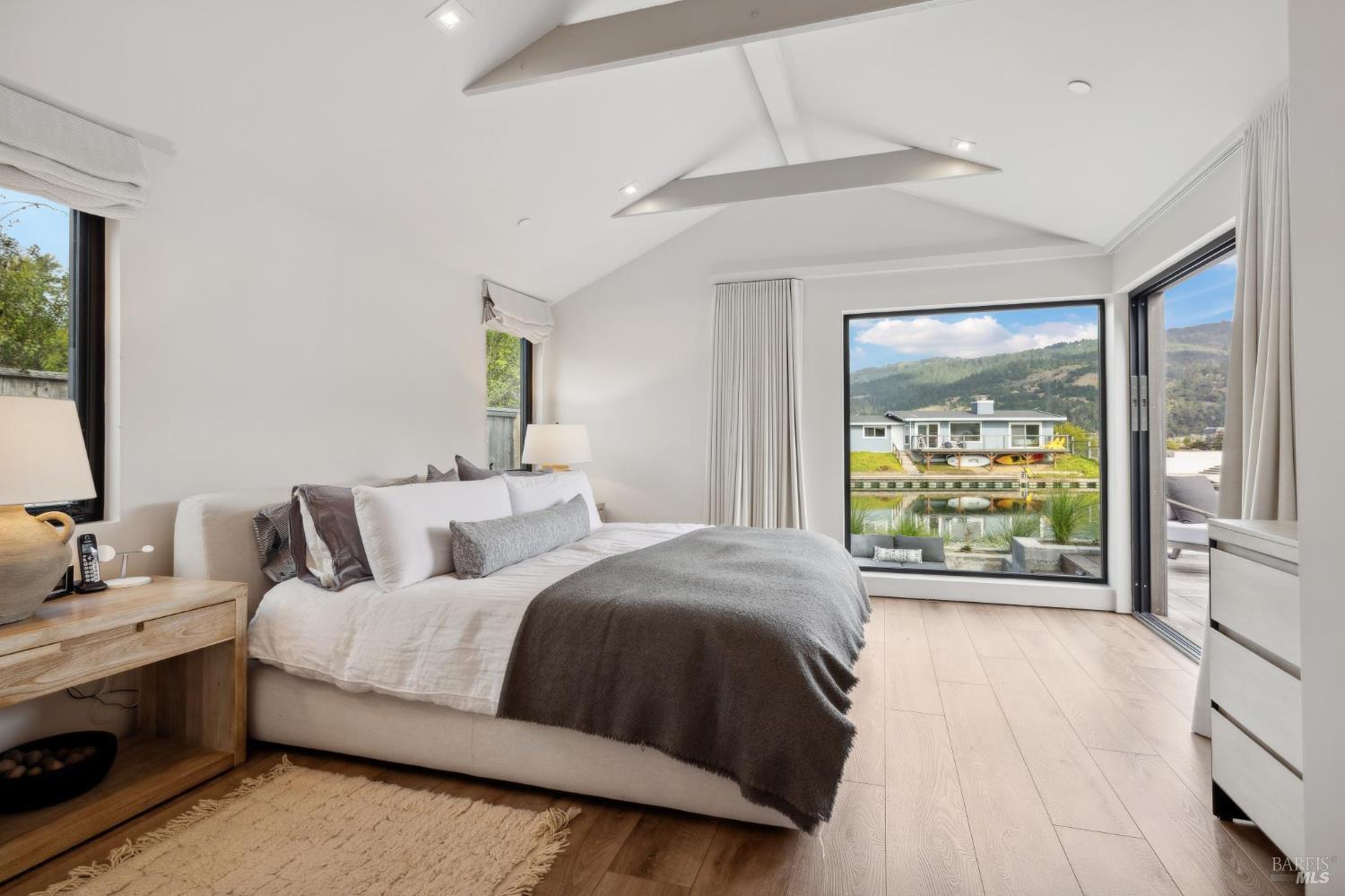 297 Seadrift Road Stinson Beach, CA 94970 - Photo 33 of 68 a bedroom with a large bed and a large window