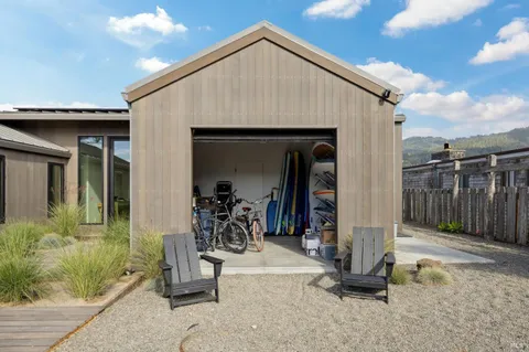 a backyard of a house with table and chairs