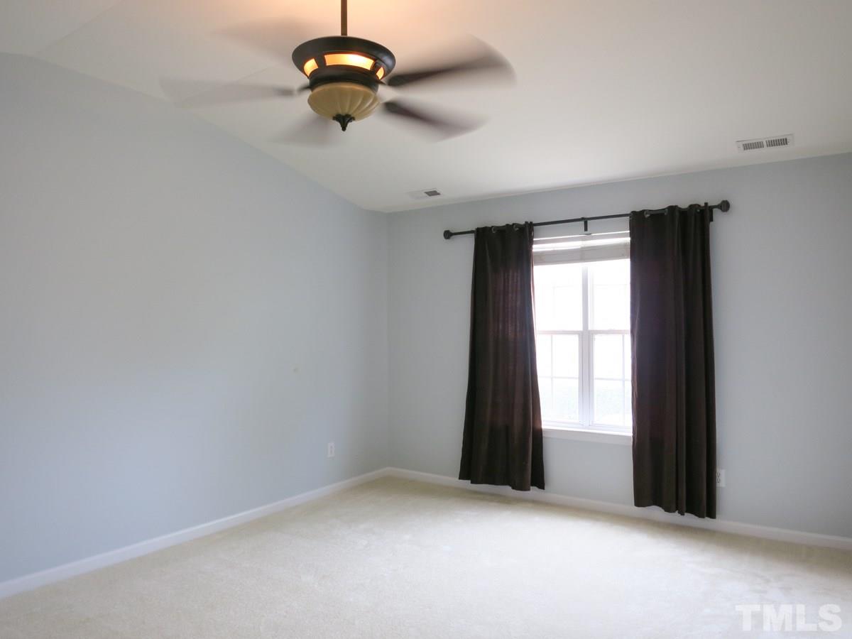8516 Barryknoll Court Raleigh, NC 27613 - Photo 13 of 25 The spacious vaulted Master Bedroom has 2 lg WICs, neutral carpet, CF & private Bath.
