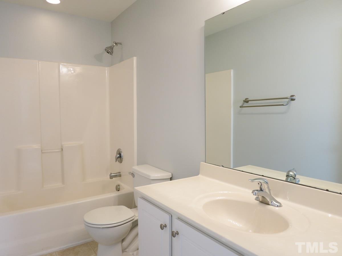 8516 Barryknoll Court Raleigh, NC 27613 - Photo 18 of 25 The 2 add’l Bedrooms share the hall Bath w/neutral vinyl floor.