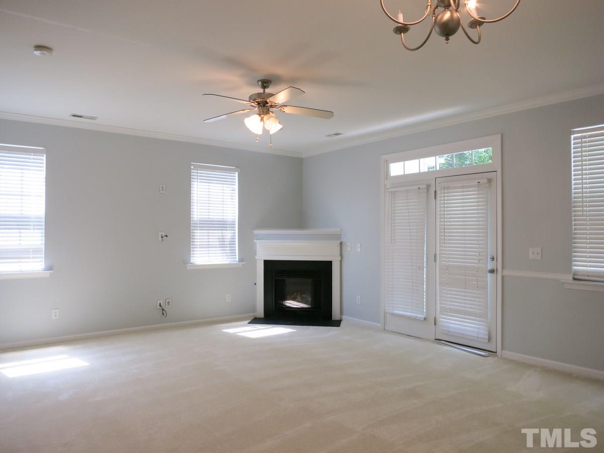 8516 Barryknoll Court Raleigh, NC 27613 - Photo 4 of 25 Home features an open Living/Dining/Kitchen area—the Living Rm has a corner gas log FP, CF, neutral carpet, crown molding & French doors to the private Patio.