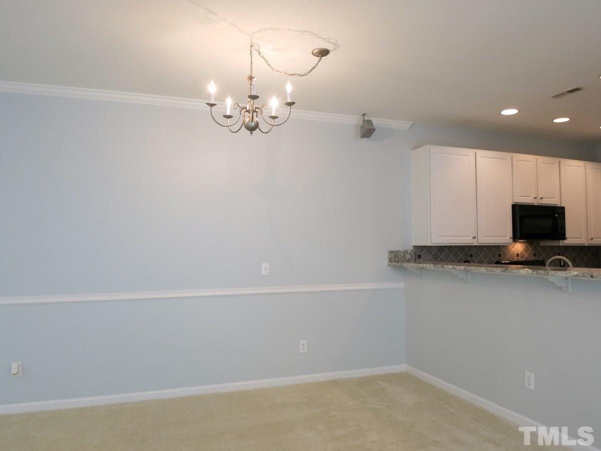 8516 Barryknoll Court Raleigh, NC 27613 - Photo 7 of 25 View of the spacious Dining area w/neutral carpet, crown molding & brushed nickel light fixture.