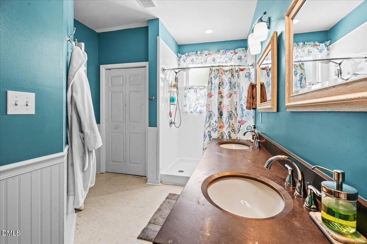 3331 Swinford Court Raleigh, NC 27604 - Photo 21 of 27 a bathroom with a sink a toilet and shower