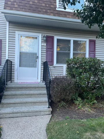 a view of house with entryway and stairs