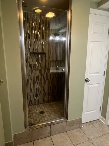 a bathroom with a glass shower door