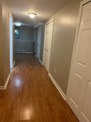 wooden floor in an empty room with a mirror