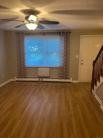 a view of a room with wooden floor