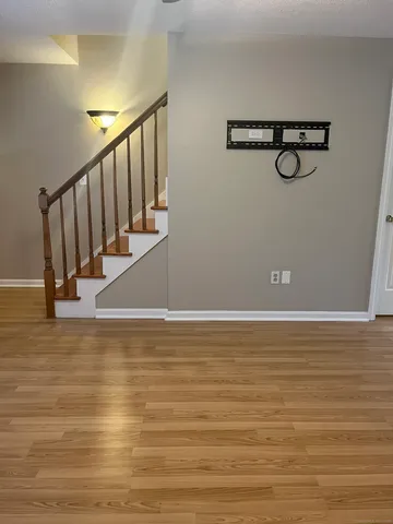 a view of room with wooden floor and windows