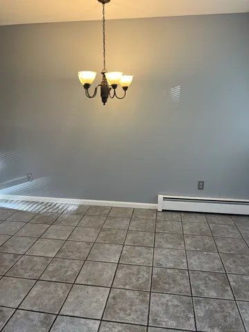 a view of a room with wooden floor and cabinets
