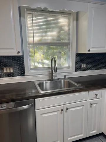 a kitchen with a sink and a window