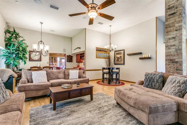 a living room with furniture and a chandelier