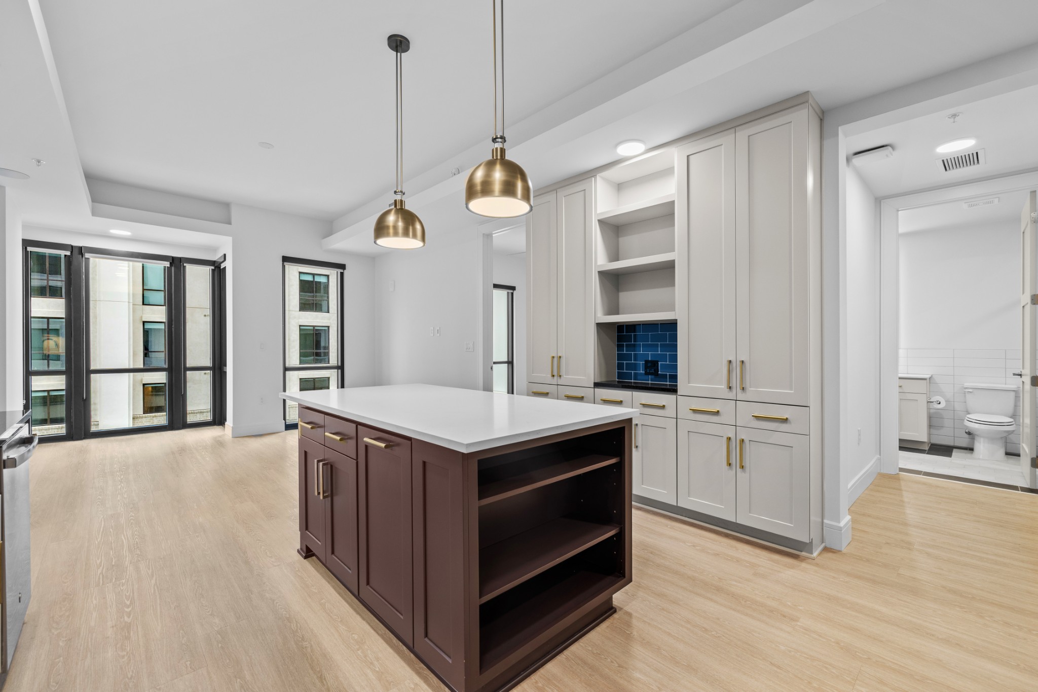 930 Commerce Street, Unit 508 Nashville, TN 37203 - Photo 12 of 65 a kitchen with a stove kitchen island and a wooden floor