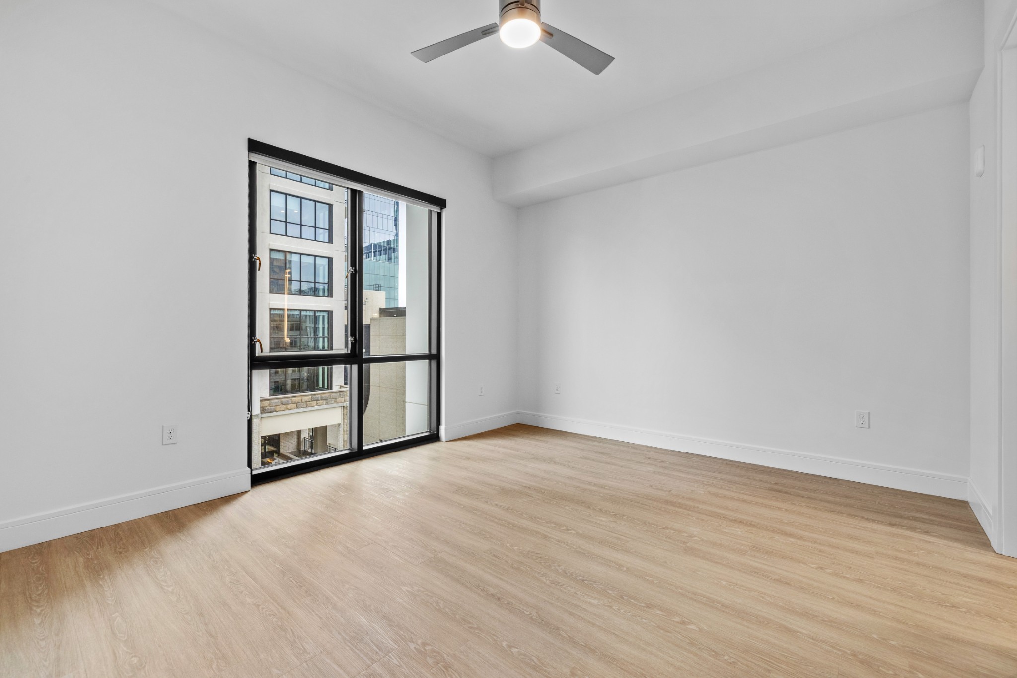 930 Commerce Street, Unit 508 Nashville, TN 37203 - Photo 15 of 65 wooden floor in an empty room with a window