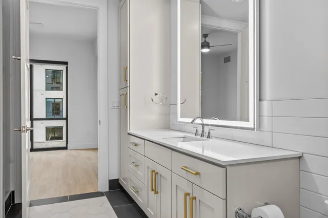 a white bath tub sitting next to a white toilet and sink