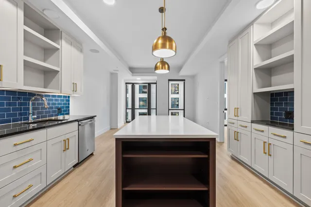 a kitchen with a stove kitchen island and a wooden floor