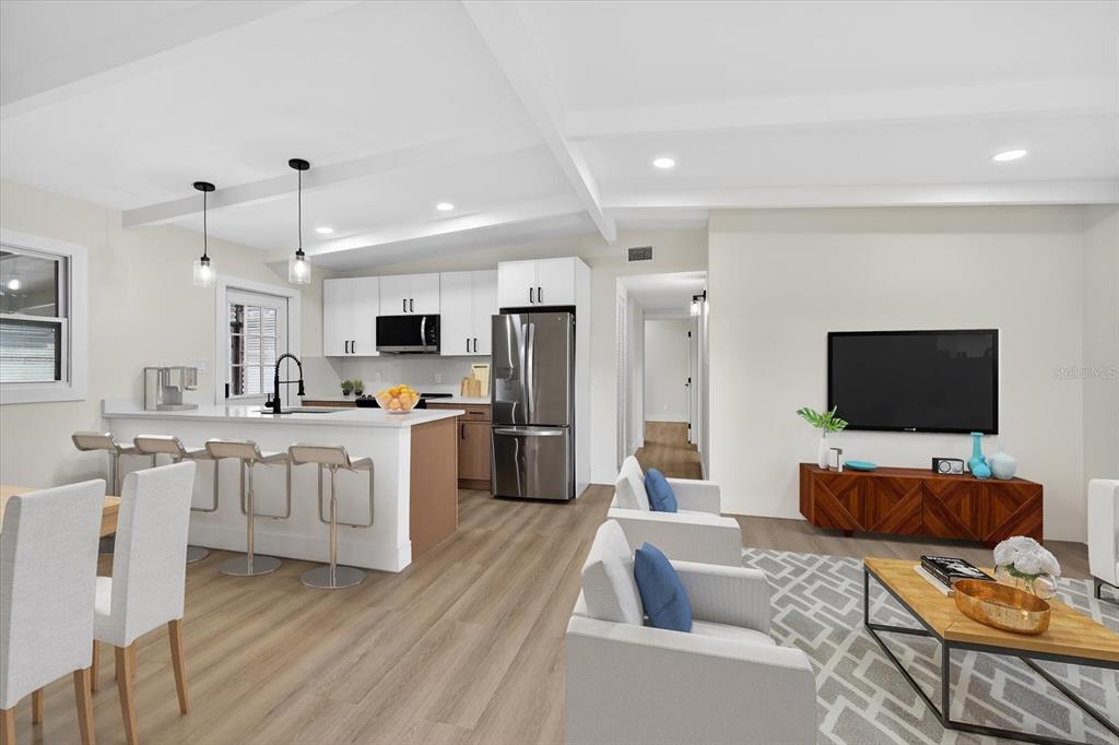 5901 South Coolidge Avenue Tampa, FL 33616 - Photo 13 of 47 a living room with furniture a flat screen tv and kitchen view