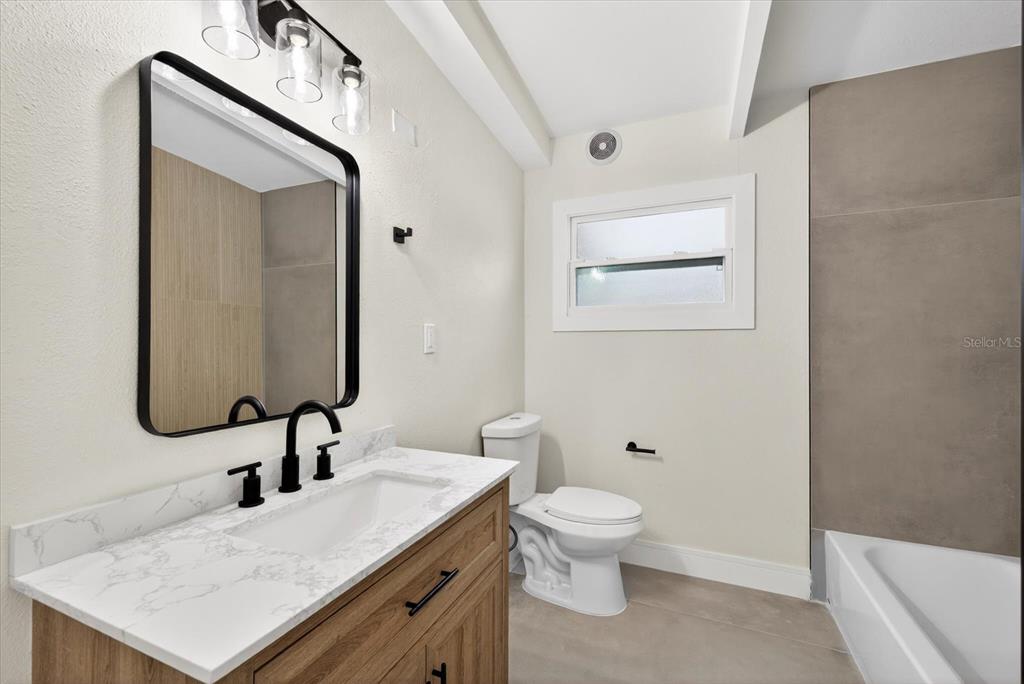 5901 South Coolidge Avenue Tampa, FL 33616 - Photo 23 of 47 a bathroom with a sink a toilet and mirror