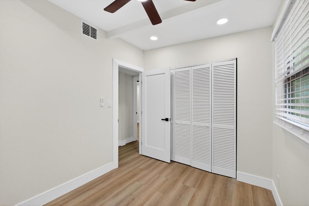 5901 South Coolidge Avenue Tampa, FL 33616 - Photo 27 of 47 an empty room with wooden floor cabinet and windows