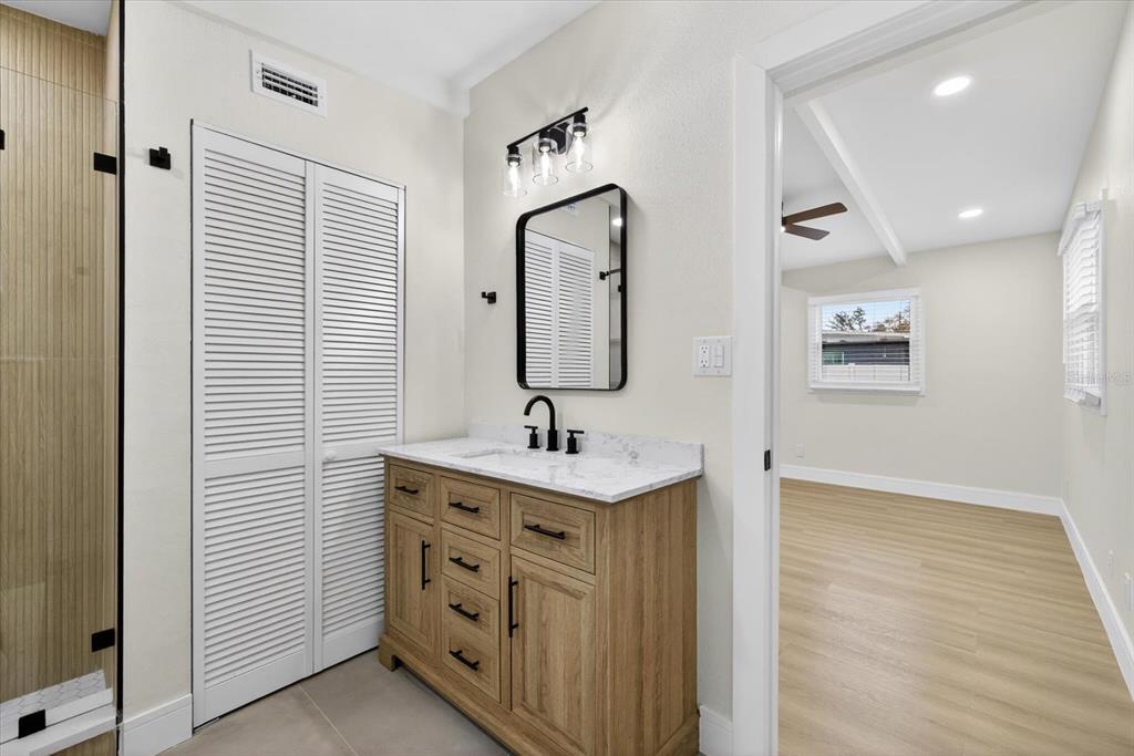5901 South Coolidge Avenue Tampa, FL 33616 - Photo 33 of 47 a bathroom with a sink a light fixture and a mirror