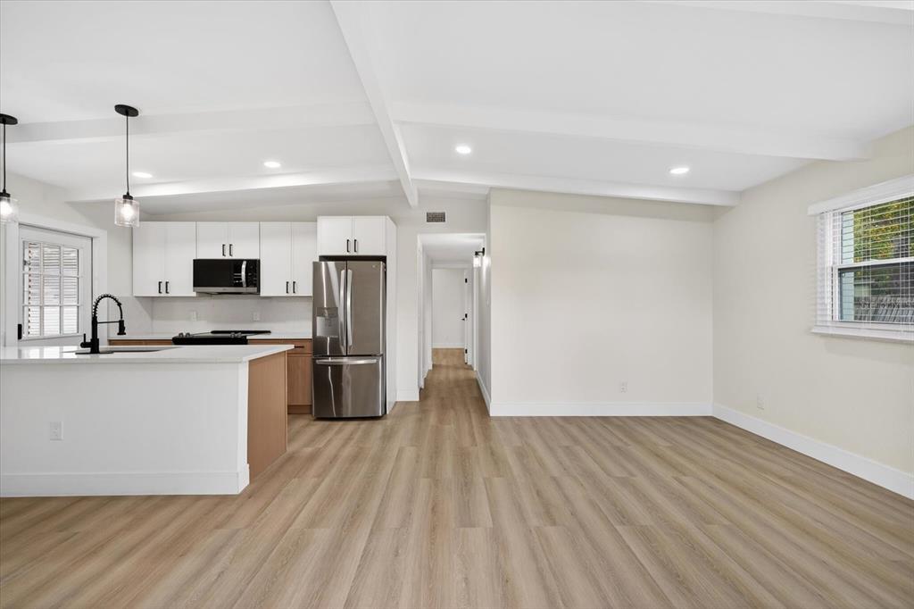 5901 South Coolidge Avenue Tampa, FL 33616 - Photo 10 of 47 a view of kitchen with stainless steel appliances granite countertop a stove top oven a refrigerator a sink and dishwasher with wooden floor