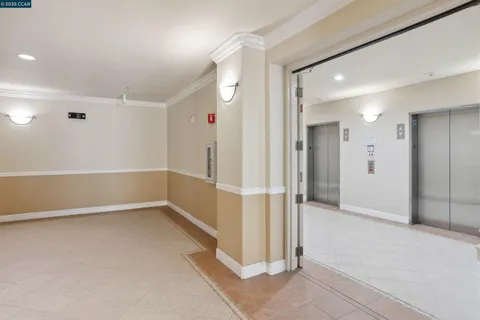 a view of a hallway with wooden shelves