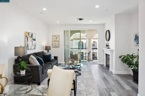 a living room with furniture a wooden floor and a chandelier