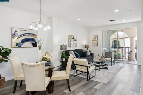a living room with furniture a fireplace and a potted plant