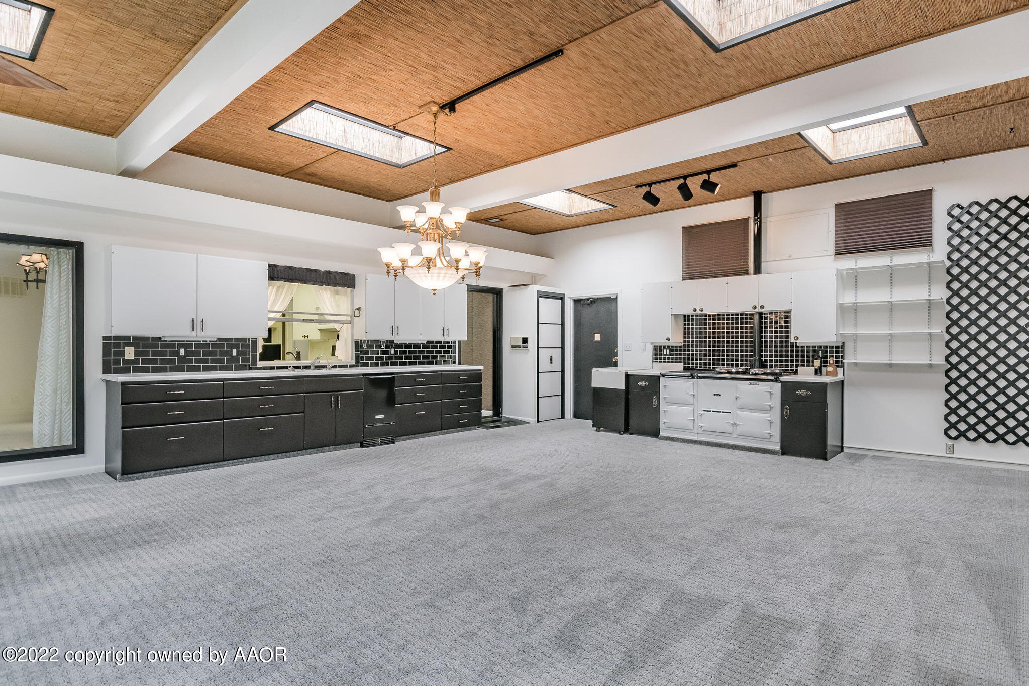 6016 Dreyfuss Road Amarillo, TX 79106 - Photo 68 of 91 a large white kitchen with stainless steel appliances kitchen island granite countertop a stove and cabinets