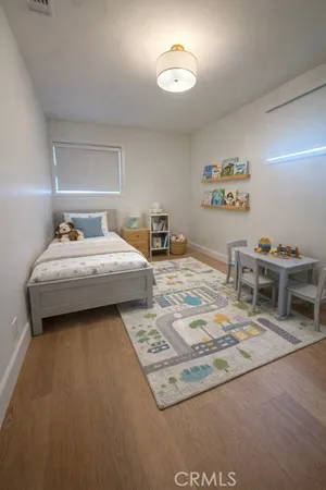 a bedroom with a bed and a desk
